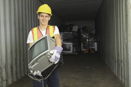 Workers conducting loft clearance services in a St Johns Wood home
